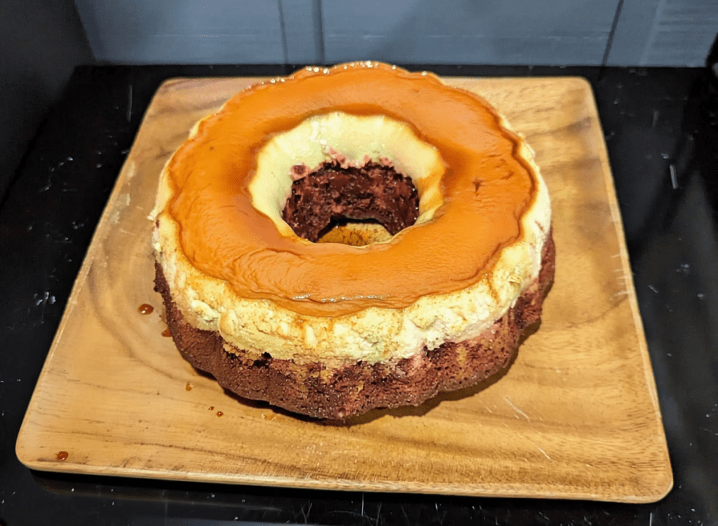 That One Place, LLC | Brazilian Flan on top of Coconut Cake